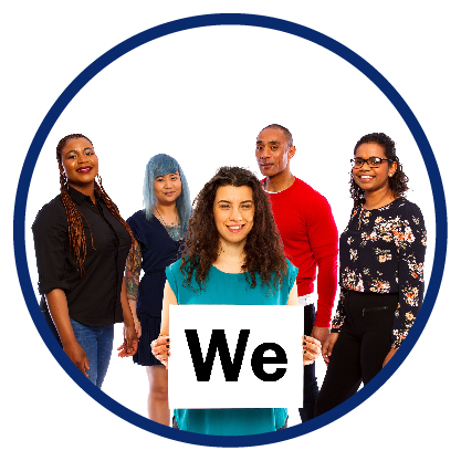 A group of people. The woman at the front is holding a card that says “we”
